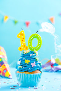 Tenth 10th birthday cupcake with candle blow out.Card mockup. Tenth 10th birthday cupcake with candle blow up and sprinkles. Card mockup.
